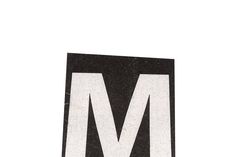 the letter m is made out of black and white paper