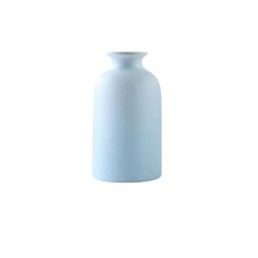 a light blue vase sitting on top of a white table