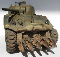 an old tank with some rust on it's front and back wheels, sitting on a white surface