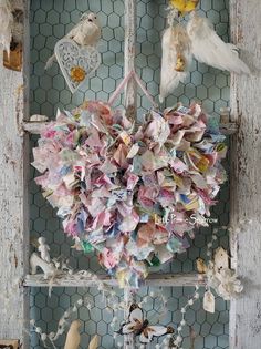 a bunch of birds that are sitting on a window sill with some paper in it