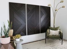 a living room with three decorative panels on the wall