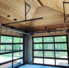 the inside of a garage with double doors and an overhead track system on the ceiling