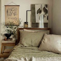 a bed sitting in a bedroom next to a window with lots of pillows on top of it