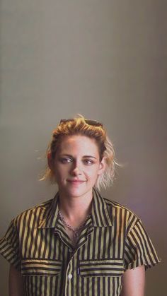 a woman in striped shirt posing for the camera