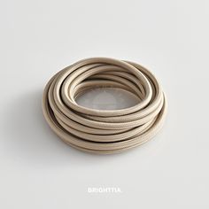 an image of a white cable on a white background with the words brighttta above it