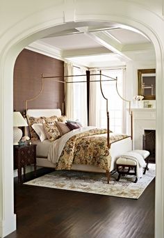 a bedroom with a canopy bed and wooden floors