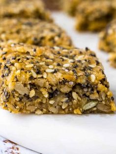 an oatmeal bar is cut in half on a cutting board