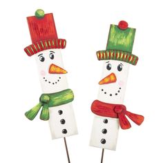 two snowmen made out of toothpicks with hats and scarves on them