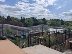 an outdoor area with several greenhouses and trees