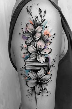 a woman's thigh with flowers and books on it, painted in black and white