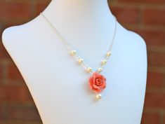 "Featuring Coral Orange Rose and Off-White Pearl Drop Necklace. * Hand Sculpted Rose . Size approx : 26-27mm across * 6 and 8mm Cream/Ivory/Off-white Pearls (Pictured). Glass Pearls and Swarovski pearls available. * Silver Plated Chain (pictured) . Antiqued Brass and Gold Plated chain available, please drop a note or convo me if you prefer different type of wire/chain. * The entire length approximately 16.1/2\" with 2 \" extender , if you prefer different length please convo me. * Packed in a gi Coral Wedding Themes, Coral Bridesmaid, Coral Flower, Coral Rose, Pearl Drop Necklace, Beaded Necklace Designs, Indian Jewellery Design Earrings, Coral Wedding, Polymer Clay Jewelry Diy