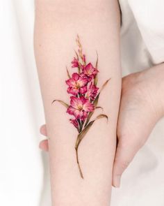 a woman's arm with pink flowers on it