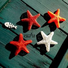 four starfishs are sitting on top of a piece of wood with the word art written below them