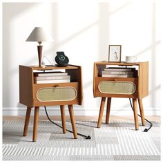 two nightstands side by side with books and magazines on them, next to a lamp