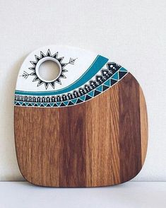 a wooden cutting board with an artistic design on it