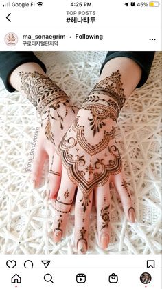 someone has their hands painted with henna