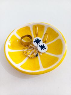 an orange slice with two wedding rings in the middle and one ring on it's side