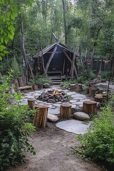 an outdoor fire pit surrounded by trees and rocks