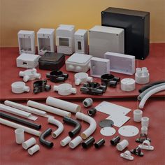 many different types and sizes of electrical components on a table with red clothed surface