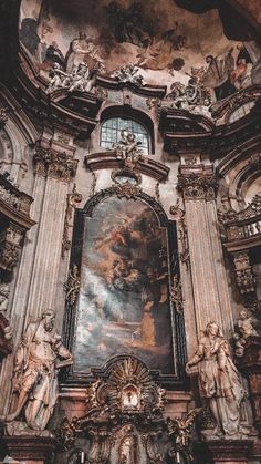 the interior of a church with statues and paintings