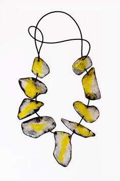 Mixed-Media Necklace - A double necklace, handcrafted from strong, synthetic paper coated with resin featuring a symphony of contrasts! The front showcases radiant yellow and white, while the back captivates in abstract in black and white, creating a layered, collage effect. Connected by a supple rubber cord, the necklace exudes both elegance and boldness. No clasp. Modern Handmade Yellow Jewelry, Layered Collage, Mixed Media Necklace, Porcelain Necklace, Double Necklace, Paper Earrings, Jewelry Knots, Professional Gifts, Artful Home