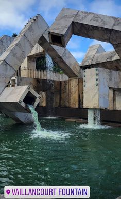 the water is green and blue with white clouds in the sky above it, there are two concrete structures that appear to be floating on top of one another structure