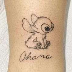 a small tattoo on the leg of a person with an elephant and name written in cursive writing