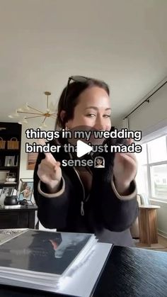 a woman sitting at a table with an open book in front of her and the caption reads things in my wedding binder that just made sense