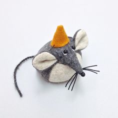 a felt mouse with a yellow hat on it's head