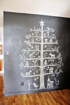 a chalkboard christmas tree is on the wall