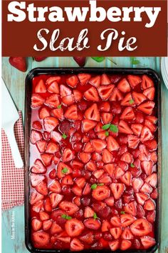 strawberry slab pie with fresh strawberries on top in a baking pan, ready to be eaten