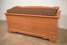 a wooden bench sitting on top of a tile floor