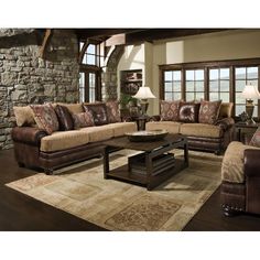 a living room filled with furniture and a stone wall