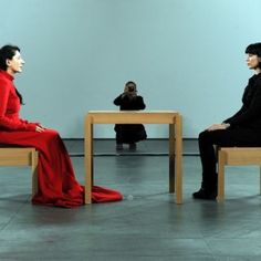 two women sitting on chairs facing each other