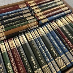 a bunch of books sitting on top of a wooden box filled with lots of them