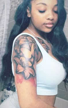 a woman with a flower tattoo on her arm