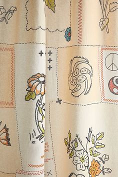 a close up of a curtain with different designs on it