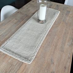 a wooden table topped with a glass filled with milk