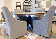 a dining room table with chairs around it and rugs on the floor next to it