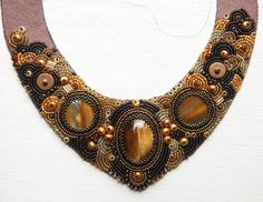 a necklace is adorned with beads and stones