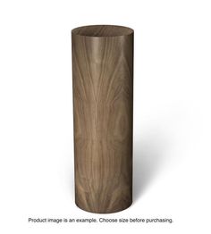 a tall wooden vase sitting on top of a white surface