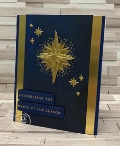 a blue and gold christmas card with stars on it