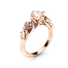 a rose cut diamond ring with three stones on the band and two leaves around it