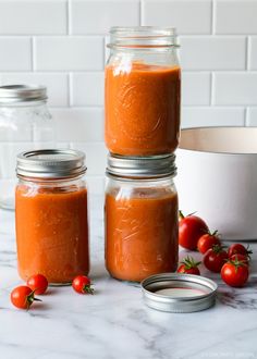 three jars filled with food sitting on top of a table