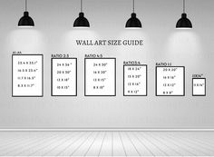 the wall art size guide is displayed in an empty room with three lamps hanging above it