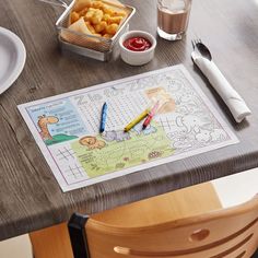 a child's activity table with food and utensils, including a crayon pen