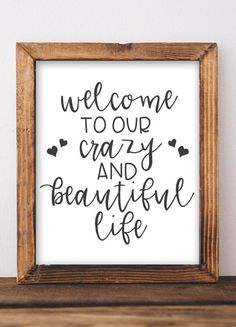 a framed sign that says welcome to our crazy and beautiful life on the side of a shelf