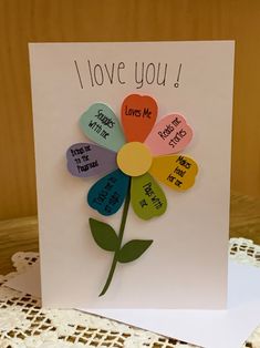 a greeting card with the words i love you written on it and a colorful flower