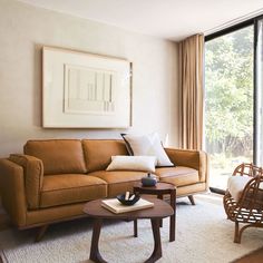 a living room filled with furniture and a large window