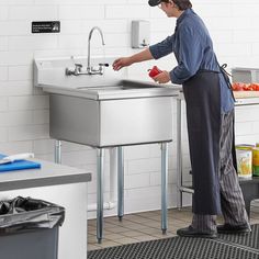 a man is washing his hands in the sink